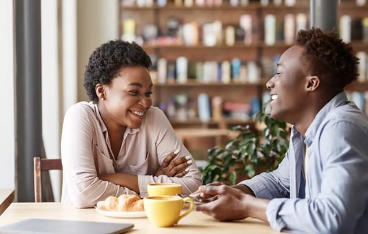 Two friends drinking warm coffee - image by Prostock-studio / shutterstock.com