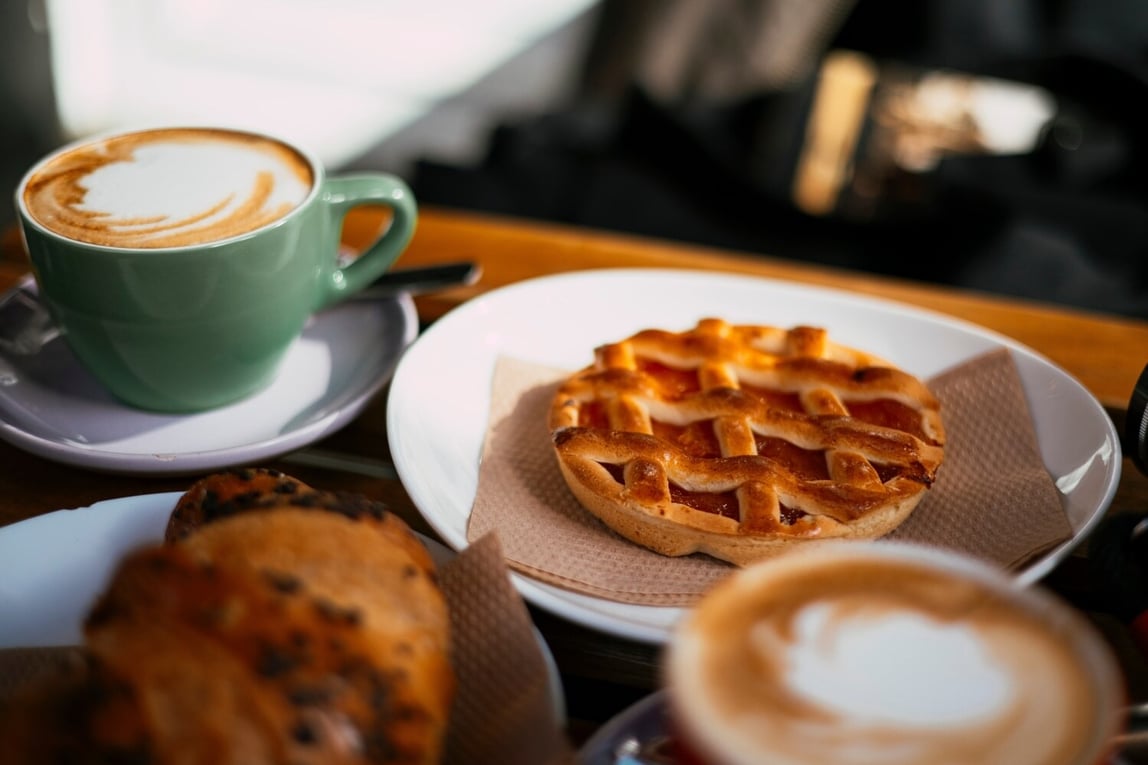 Close up cappuccino, chocolate croissant and apricot crostatina. Image by Andrei Molchan / Shutterstock.com